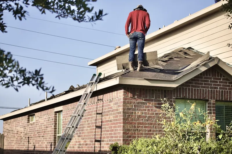 Professional roofer working on a residential roof in Farmland Acres